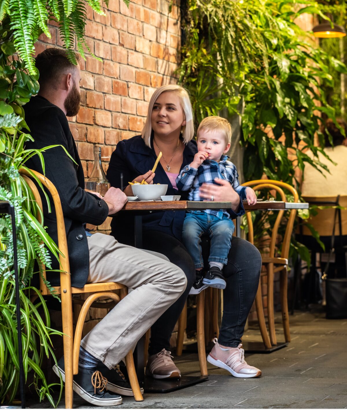 Young family enjoying café in Northcote, Auckland.